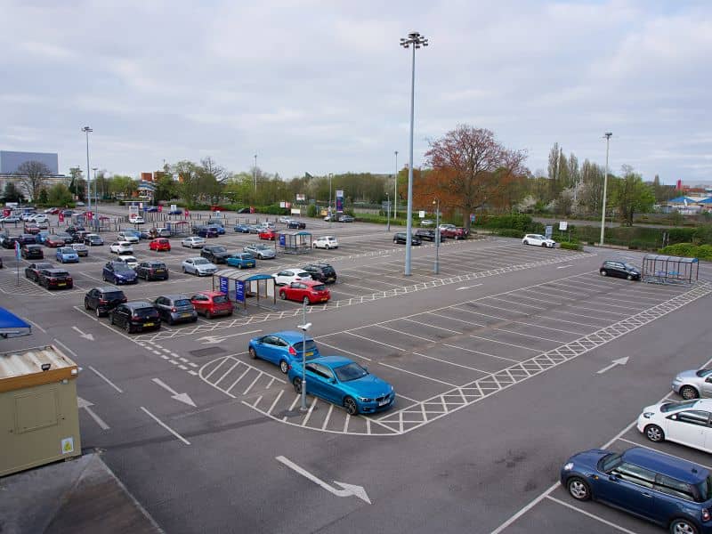 Large commercial parking lot with drive lanes and parking spaces evaluated during an ALTA Survey for redevelopment planning